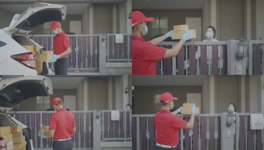4 k慢动作视频。一名身穿红色制服的男性快递员寄包裹盒子在寄给收件人之前喷洒清洁酒精新标准的概念。高清在线视频素材下载