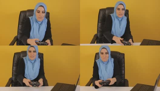 穆斯林女商人在工作中玩游戏高清在线视频素材下载