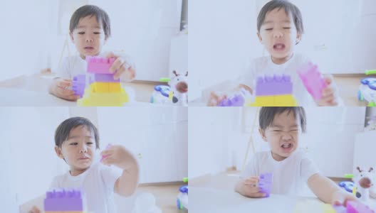 亚洲婴儿玩彩色塑料砖高清在线视频素材下载