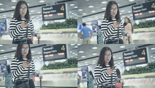 一名泰国女子在机场使用智能手机高清在线视频素材下载