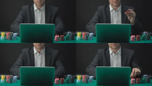穿着西装的男人在笔记本电脑上在线赌博，手里拿着赌场筹码，打赌高清在线视频素材下载