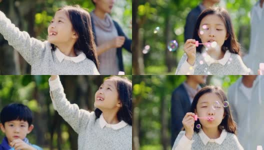 一个亚洲小女孩在公园里吹泡泡高清在线视频素材下载