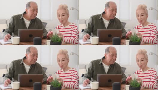 日本一对老年夫妇在笔记本电脑上处理家庭财务高清在线视频素材下载