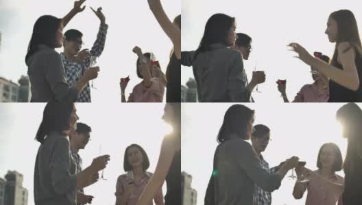 人们庆祝有乐趣和喝葡萄酒在屋顶派对高清在线视频素材下载