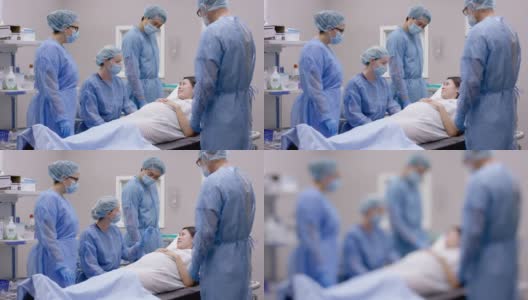 一名白人医生和她的手术团队为孕妇做手术高清在线视频素材下载