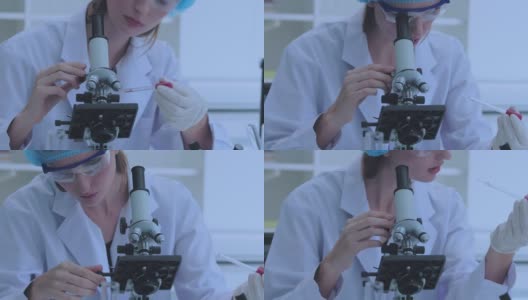 女科学家正在实验室里用显微镜进行研究。高清在线视频素材下载