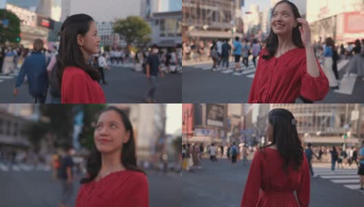 身着红裙的年轻女子站在涉谷十字路口，望着别处高清在线视频素材下载