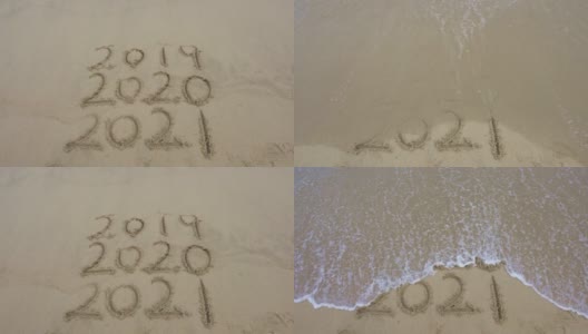 在美丽的海滩背景上的沙子上手写的2021年消息。新年的概念。高清在线视频素材下载