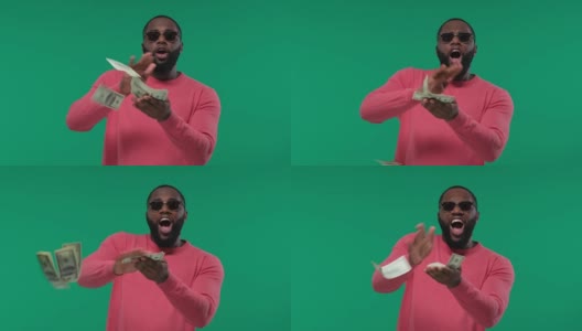 快乐的非裔美国人扔美元钞票，浪费钱，在绿色屏幕上，色度键高清在线视频素材下载