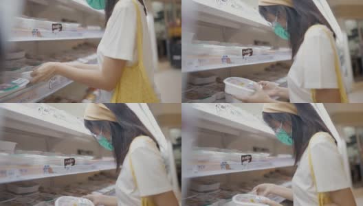 一位女士在超市里戴着防护口罩。高清在线视频素材下载