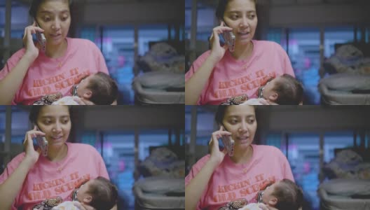 亚洲妈妈在电话里工作抱着熟睡的小男孩。高清在线视频素材下载