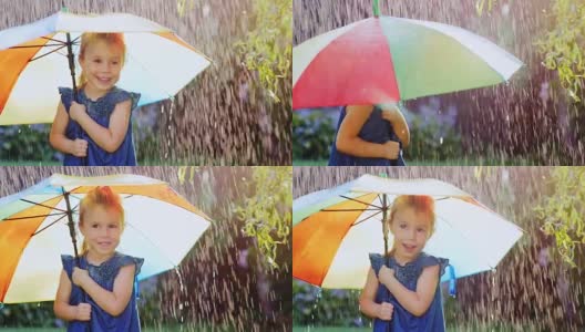 无忧无虑的女孩三年的伞下的颜色。躲避雨高清在线视频素材下载
