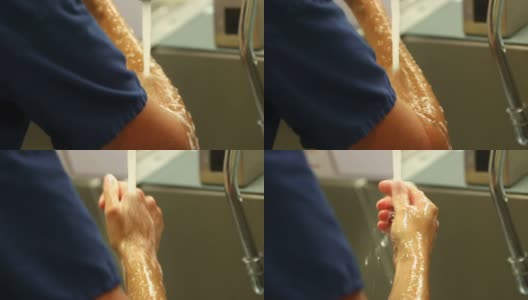 女外科医生在擦洗手臂后冲洗手臂高清在线视频素材下载