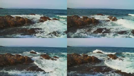 在多岩石的海岸上冲浪高清在线视频素材下载
