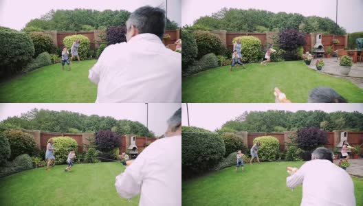 一家人在花园里打水仗高清在线视频素材下载