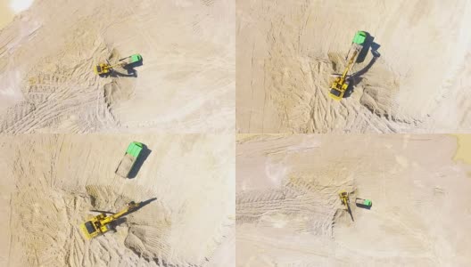 无人驾驶飞机在露天矿山的挖掘机上飞行。高清在线视频素材下载