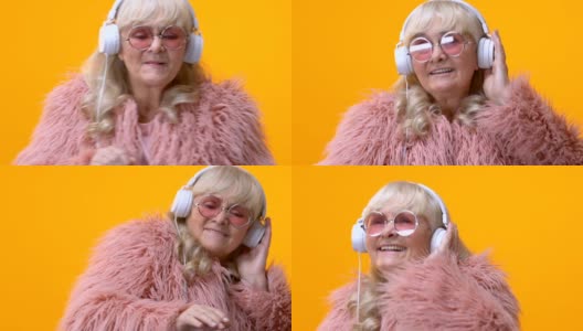 戴着白色耳机的酷奶奶随着音乐舞动，假装自己是dj，很有趣高清在线视频素材下载