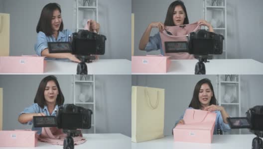 快乐美丽的亚洲女人拆箱从品牌或她的订户的礼物。女博主从相机录制视频，拍摄开箱视频。高清在线视频素材下载