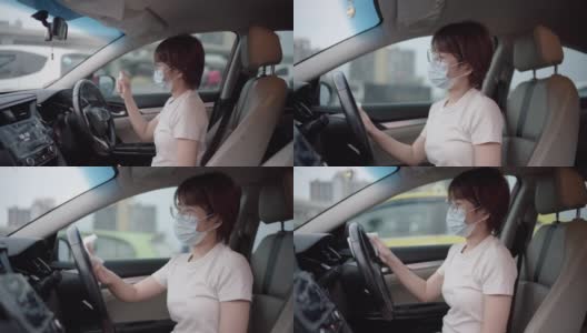 坐在车里的女人戴着保护面膜。健康保护高清在线视频素材下载
