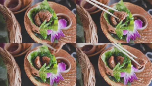 吃泰国鱼饼，或者用筷子夹上甜辣酱的蛤蟆门Pla Krai高清在线视频素材下载