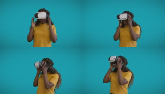 惊奇的视频游戏玩家戴着虚拟现实眼镜在蓝色背景下模拟高清在线视频素材下载