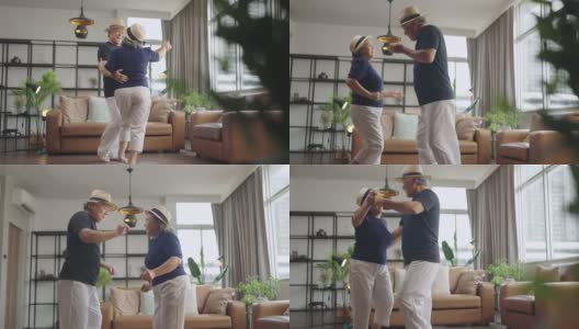 幸福退休亚洲人爱夫妇退休老夫妇在家，亚洲老夫妇一起跳舞笑笑喜气在客厅在家隔离呆在家封锁概念高清在线视频素材下载