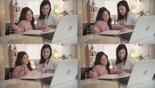 迷人的妈妈和她的女儿在一起做作业的时候玩得很开心高清在线视频素材下载