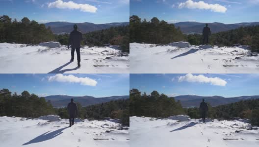 一个人走在雪山上，望着绿色的山谷。Guadarrama马德里。高清在线视频素材下载