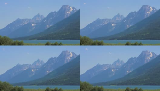 黄石公园，美国- 2021年7月。雄伟的空中无人机视图山谷与湖和美丽的雪山和绿色的小山。高清在线视频素材下载