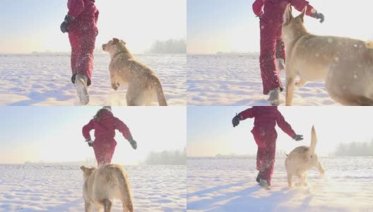 慢动作女孩和她的小狗在雪中奔跑高清在线视频素材下载