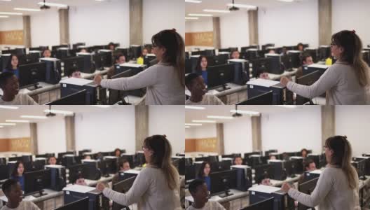 在大学计算机室内与多种族学生合作的成熟教师高清在线视频素材下载