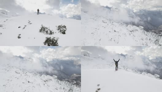 空中滑雪旅行者得意洋洋地在山顶举起双手高清在线视频素材下载