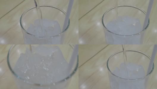 在玻璃杯中倒入干净的饮用水以澄清冰块高清在线视频素材下载