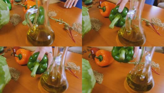 一个女人的手从桌上拿起一个甜椒。高清在线视频素材下载