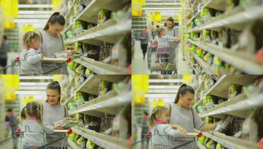 女人和女孩在超市选购产品。妈妈和女儿在篮子里放了一些商品后沿着超市的货架走高清在线视频素材下载