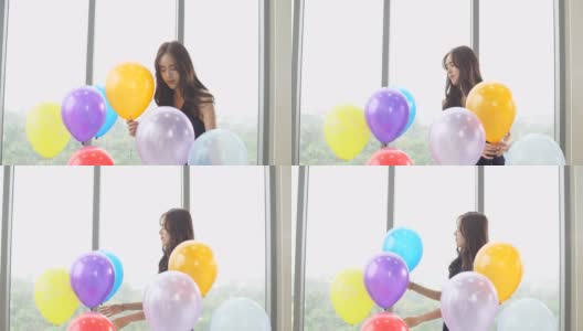 亚洲妇女在新年派对上装饰气球高清在线视频素材下载