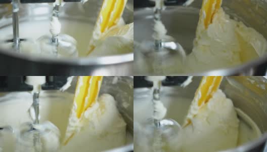 近距离观察搅拌机搅拌美味奶油制作蛋糕的过程。高清在线视频素材下载