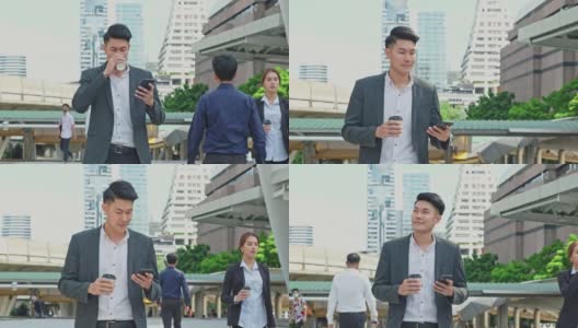 聪明的亚洲年轻商人在城市里使用智能手机。拿着电话的男人微笑着走到外面的办公室。以电信和移动网络为经营理念。高清在线视频素材下载