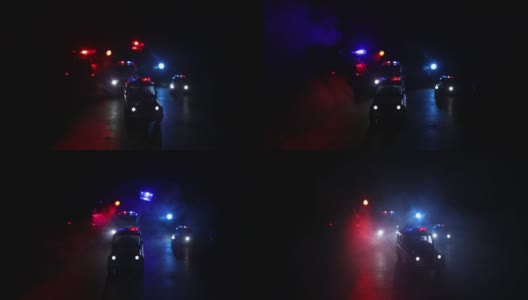 警车在晚上。一辆警车在雾中追赶一辆汽车。911紧急反应警车超速驶往犯罪现场。有选择性的重点高清在线视频素材下载