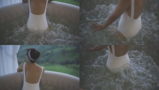 快乐年轻女子泳装在泡泡按摩浴缸享受自然景观高清在线视频素材下载