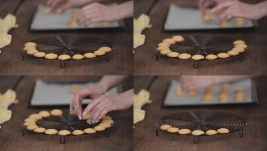 女糕点师把小香草饼干放在冷却架上。高清在线视频素材下载