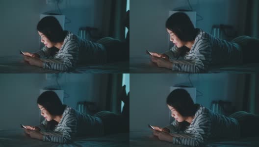 开朗的年轻女性在晚上发短信高清在线视频素材下载