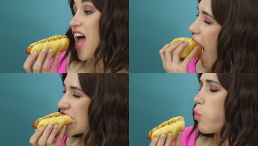 一个女人在吃蘸酱的热狗。高清在线视频素材下载
