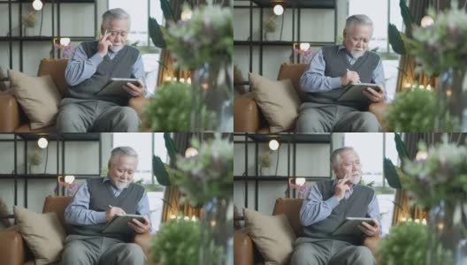亚洲老年人养老退休老人手用平板电脑冲浪社交媒体浏览朋友在线社交沟通距离连接，幸福亚洲老人呆在家里使用平板设备在家高清在线视频素材下载