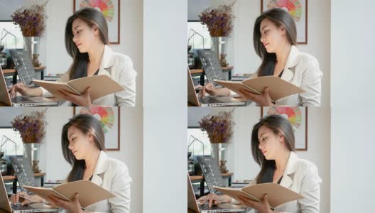 4K视频，美丽的亚洲商务女性坐在电脑笔记本输入数据，阅读和翻页笔记本在咖啡馆咖啡馆在早上的城市，商务人士的生活方式。高清在线视频素材下载