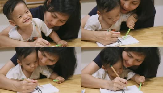 小男孩和妈妈在一起画画。高清在线视频素材下载