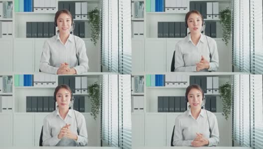 亚洲美女与人力资源经理视频电话面试。美女戴着耳机，用笔记本电脑与办公室公司进行虚拟在线会议讨论应聘工作。高清在线视频素材下载