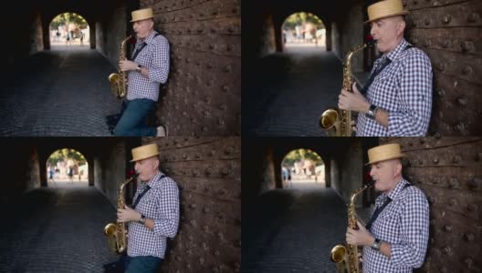 戴着帽子的街头音乐家吹萨克斯风高清在线视频素材下载