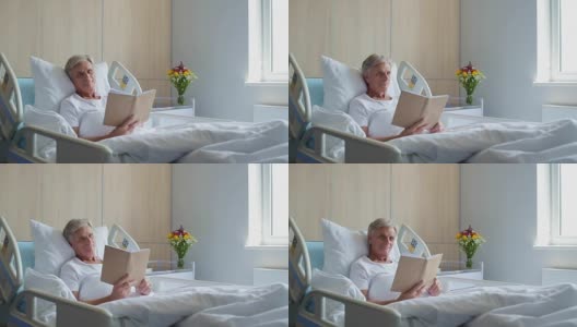 愉快的老住院病人在床上看书高清在线视频素材下载