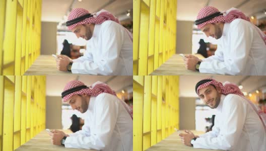阿拉伯中东男子在便利店使用手机的肖像高清在线视频素材下载